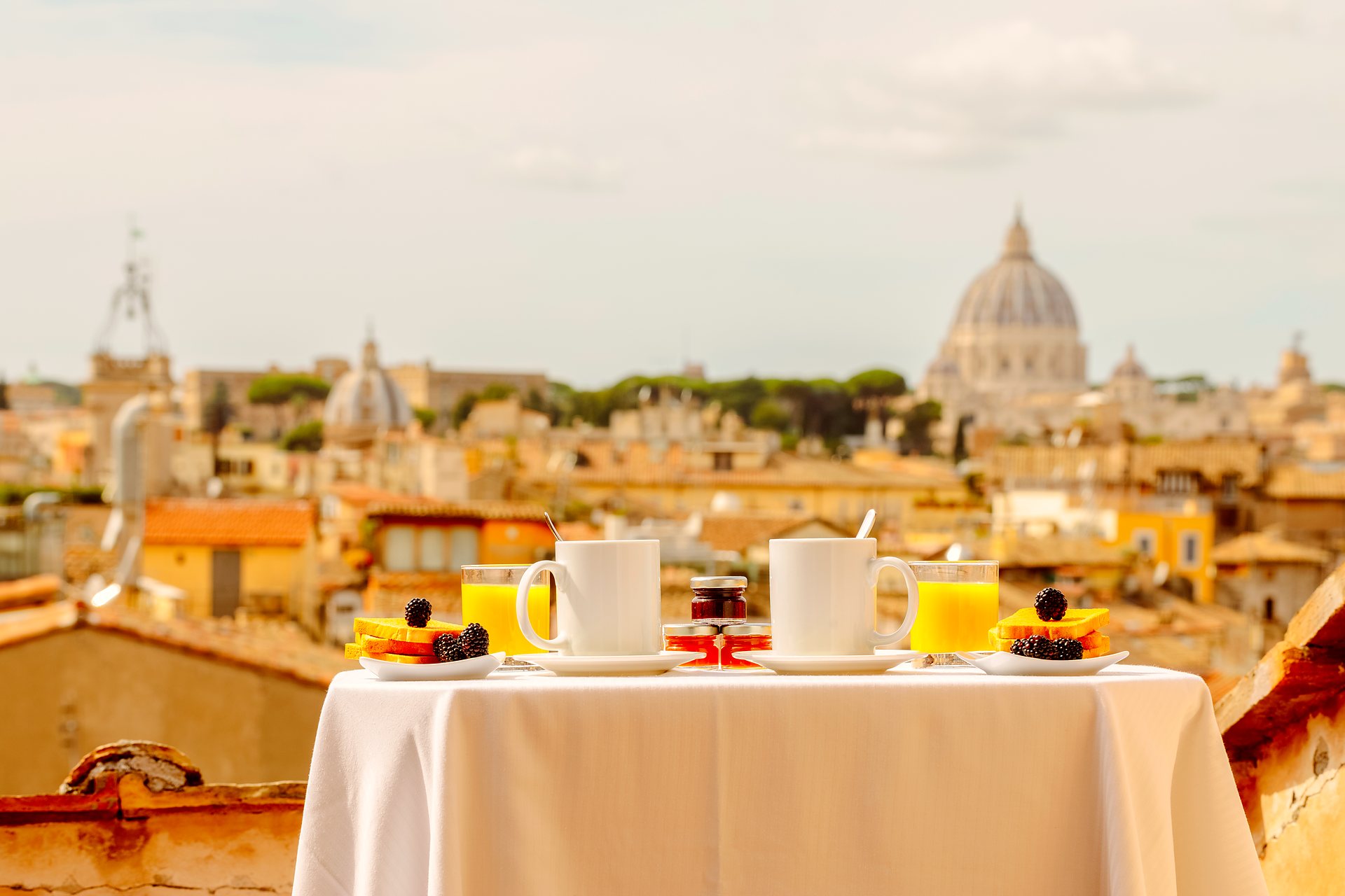 Breakfast on a rooftop terrace overlooking the domes of Rome